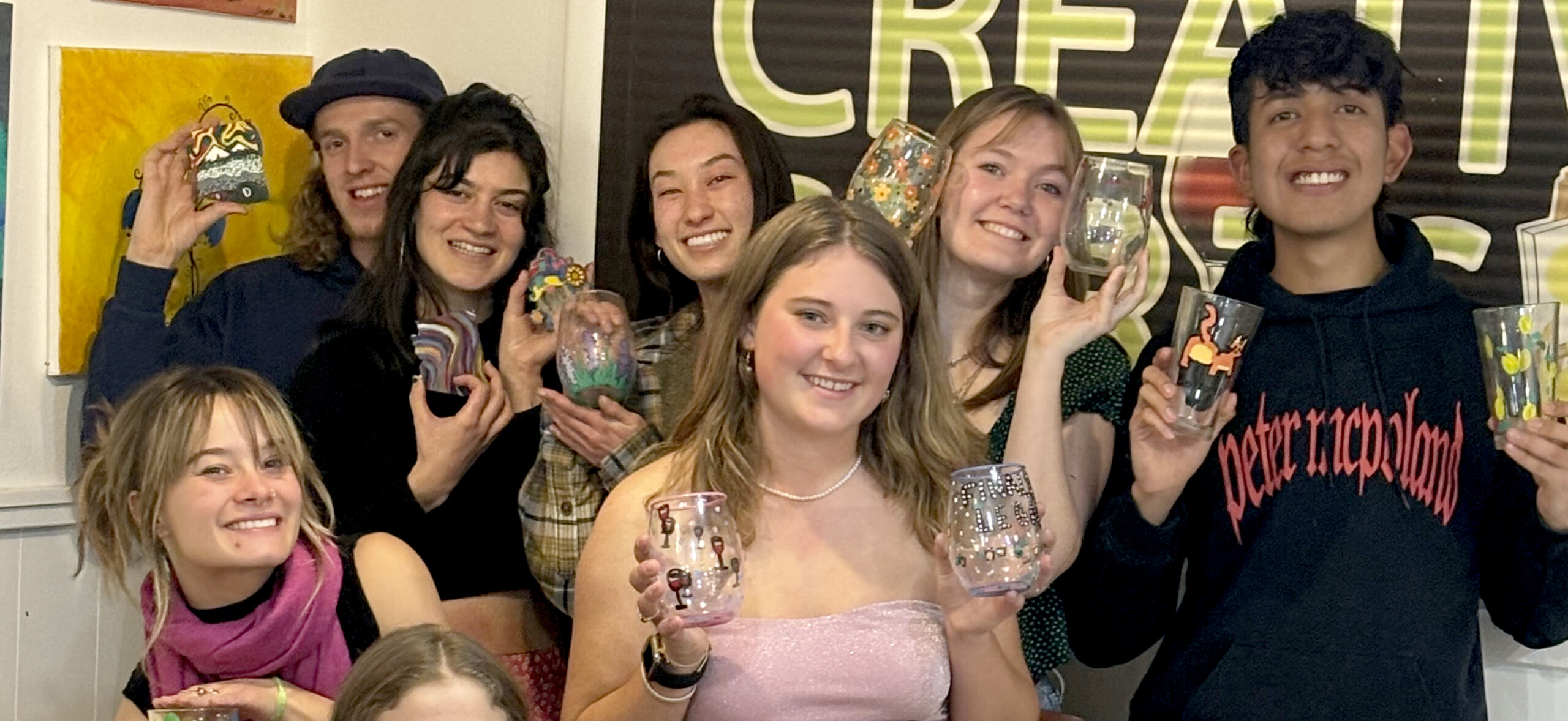 A group of people holding up their cell phones. A group of people holding up their cell phones.